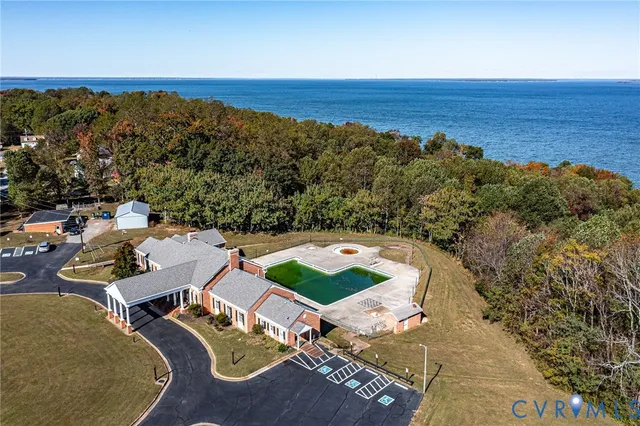 an aerial view of a house with a ocean view