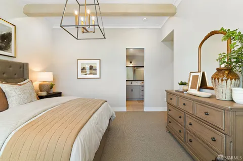 a spacious bedroom with a bed and a dresser