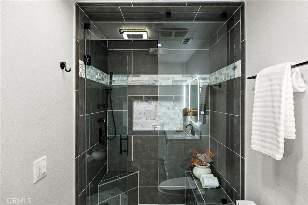 168 23rd Street, Unit D Costa Mesa, CA 92627 - Photo 16 of 26 a bathroom with a glass shower door