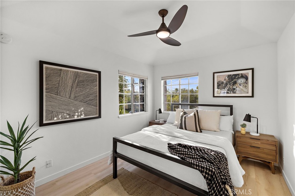 168 23rd Street, Unit D Costa Mesa, CA 92627 - Photo 18 of 26 a bedroom with a large bed and a chandelier