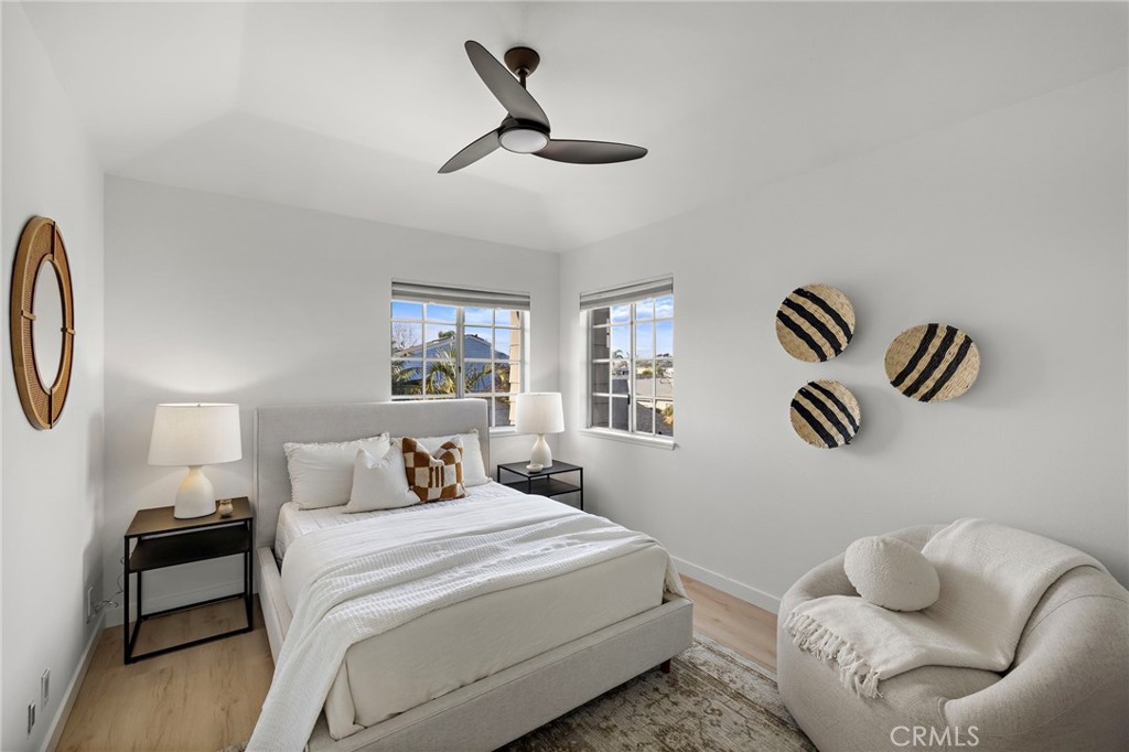 168 23rd Street, Unit D Costa Mesa, CA 92627 - Photo 20 of 26 a bedroom with a bed and wooden floor