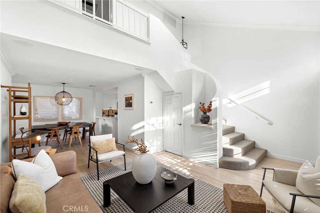 168 23rd Street, Unit D Costa Mesa, CA 92627 - Photo 3 of 26 a living room with furniture and wooden floor