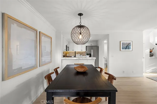 a living room with dining table and chairs
