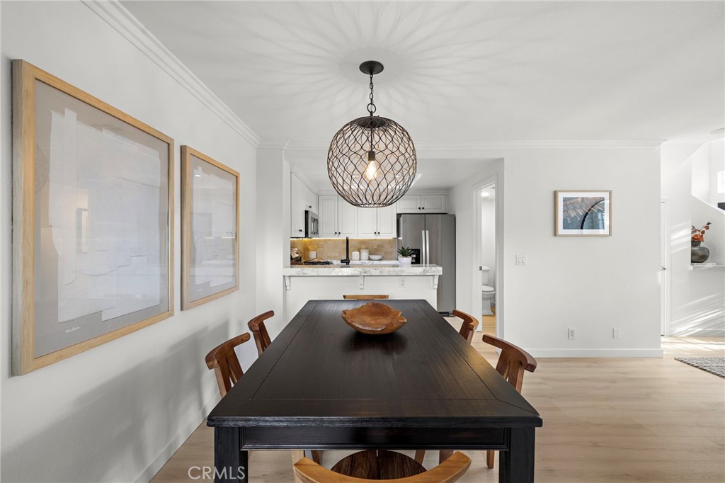 168 23rd Street, Unit D Costa Mesa, CA 92627 - Photo 7 of 26 a living room with dining table and chairs