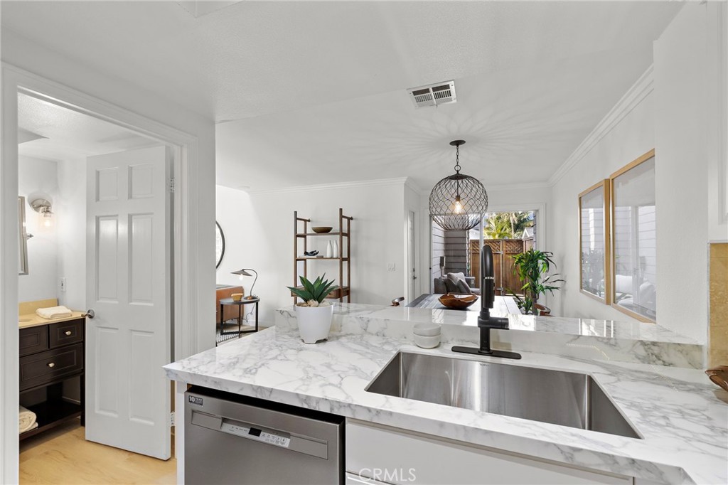 168 23rd Street, Unit D Costa Mesa, CA 92627 - Photo 9 of 26 a kitchen with a sink and a refrigerator