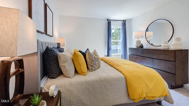 a bedroom with a bed and painting on the wall