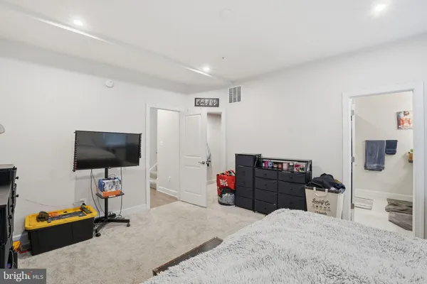 a bedroom with a workspace and a couch