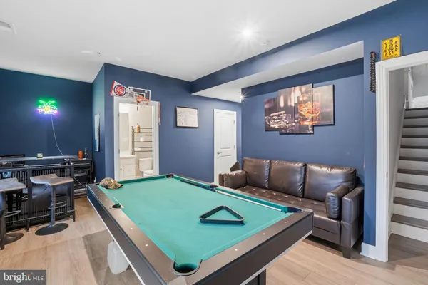 a living room with furniture and a pool table