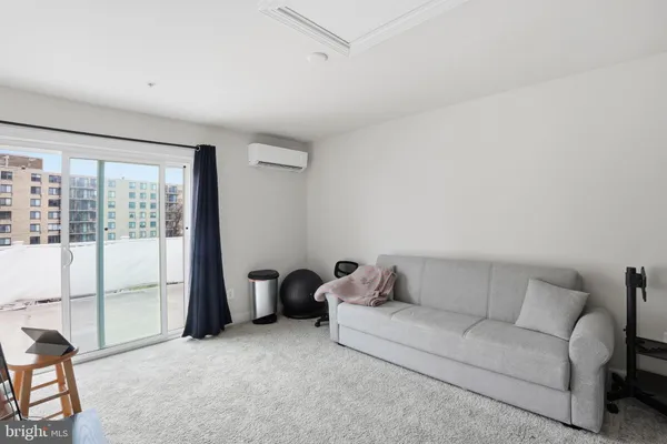 a living room with furniture and a floor to ceiling window