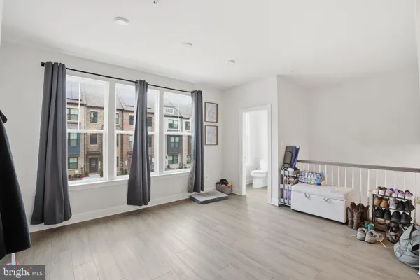 a view of a room with furniture and windows