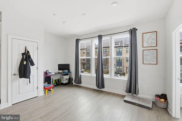 a view of a livingroom with hardwood floor and workspace