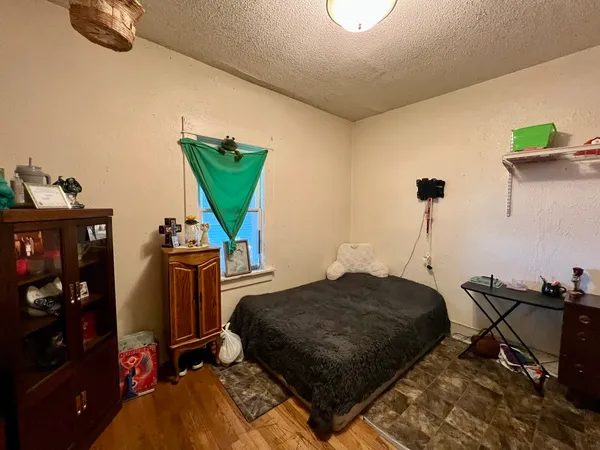a bedroom with furniture and a wooden floor