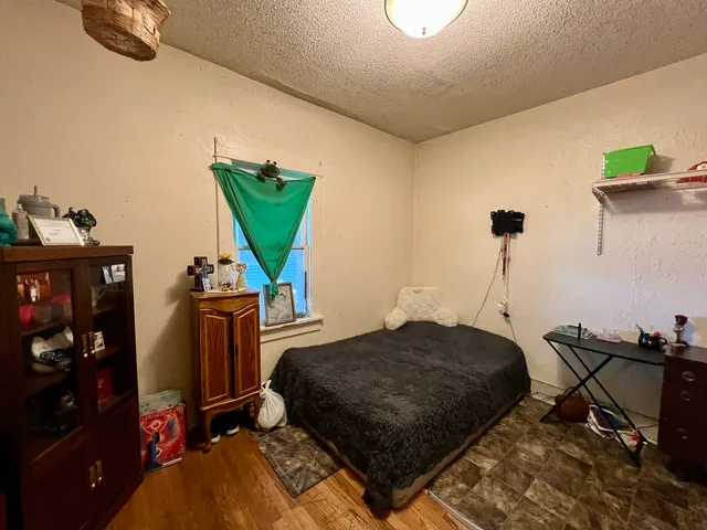 a bedroom with furniture and a wooden floor