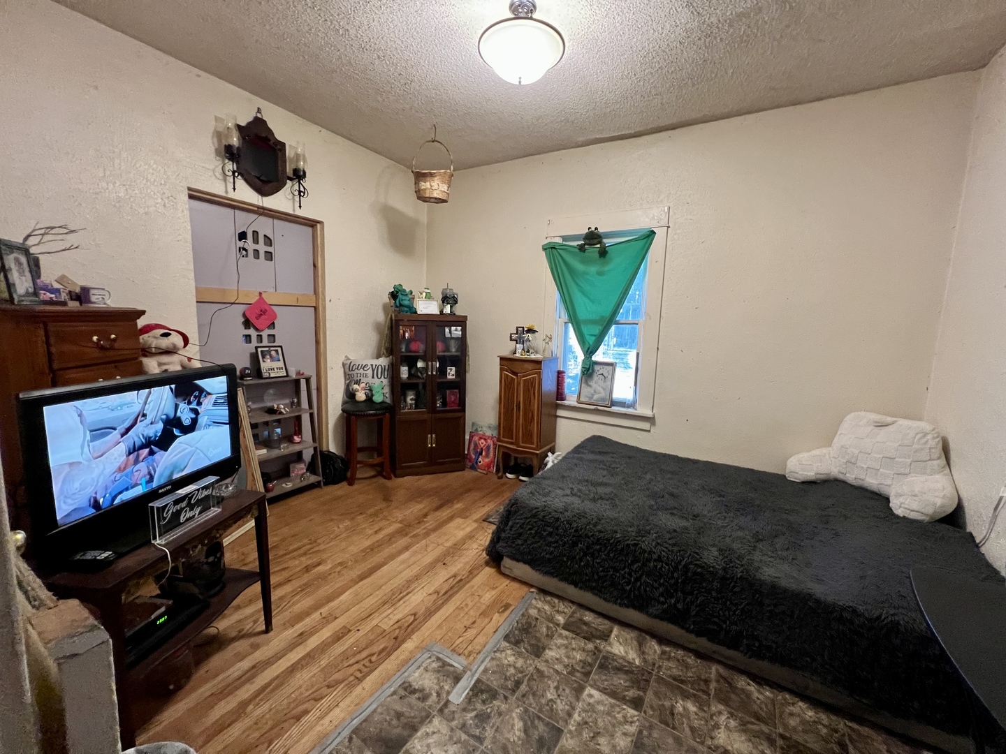 514 West Harrison Street Villa Grove, IL 61956 - Photo 12 of 21 a bedroom with bed and a flat screen tv