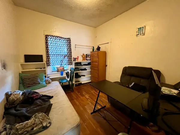 a bedroom with a bed and a couch