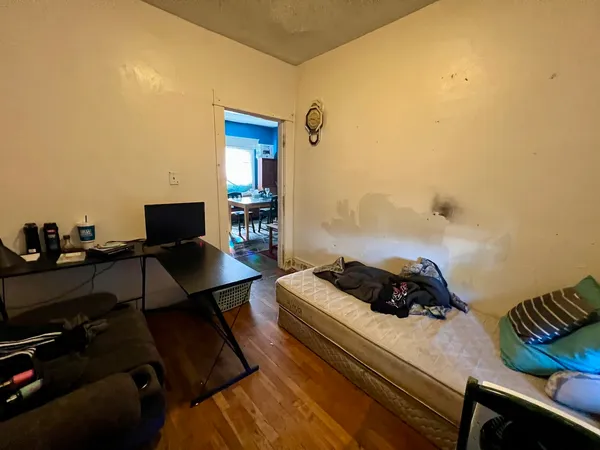 a bedroom with a bed and a desk