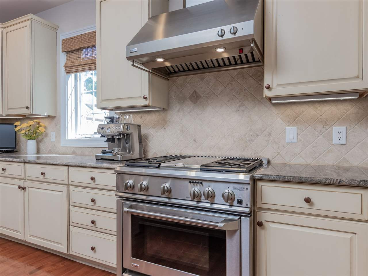 4717 Haleytree Court Raleigh, NC 27606 - Photo 12 of 30 Professional styled gas range with deluxe vent hood! with heat lamps! You'll want to try those new recipes here! Kitchen