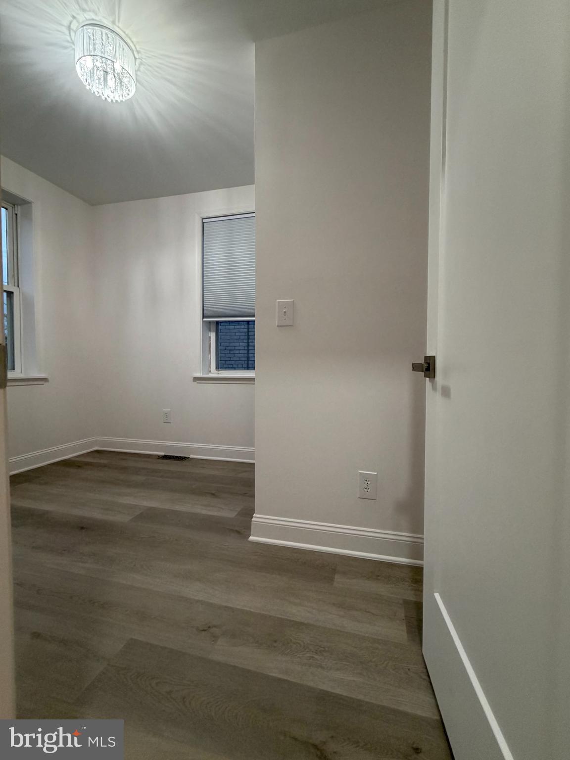 726 Roxboro Place Northwest Washington, DC 20011 - Photo 11 of 21 an empty room with wooden floor and windows