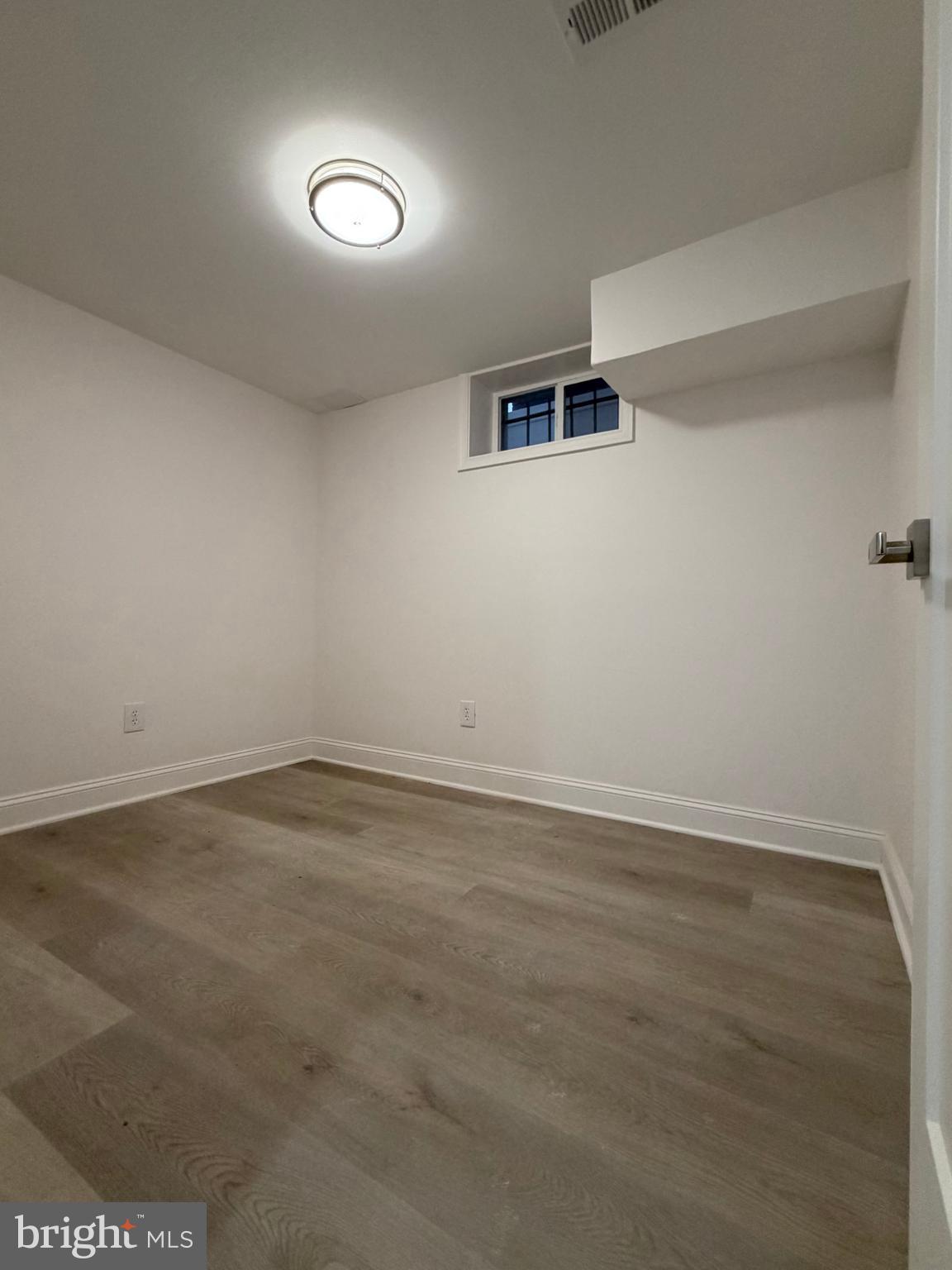 726 Roxboro Place Northwest Washington, DC 20011 - Photo 17 of 21 an empty room with wooden floor and windows