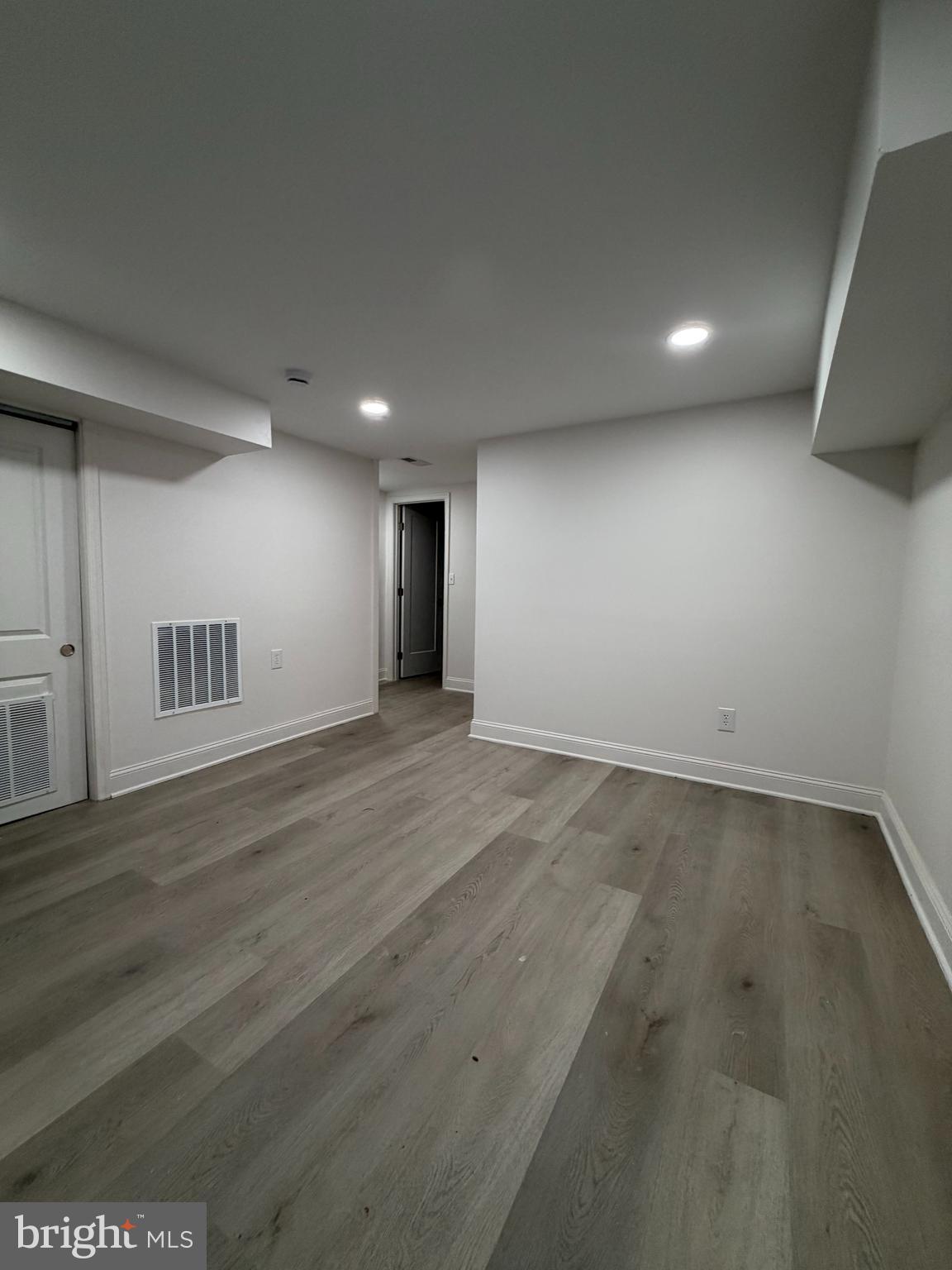 726 Roxboro Place Northwest Washington, DC 20011 - Photo 19 of 21 an empty room with wooden floor and natural light
