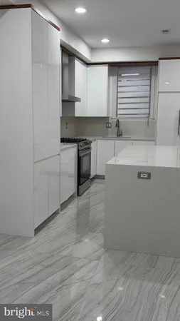 a kitchen with stainless steel appliances granite countertop a sink and cabinets