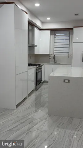 a kitchen with stainless steel appliances granite countertop a sink and cabinets