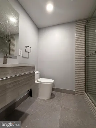 a bathroom with a sink a toilet and mirror