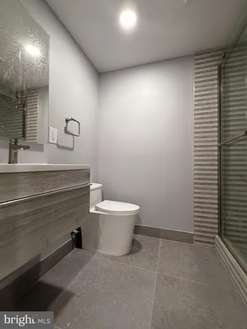a bathroom with a sink a toilet and mirror