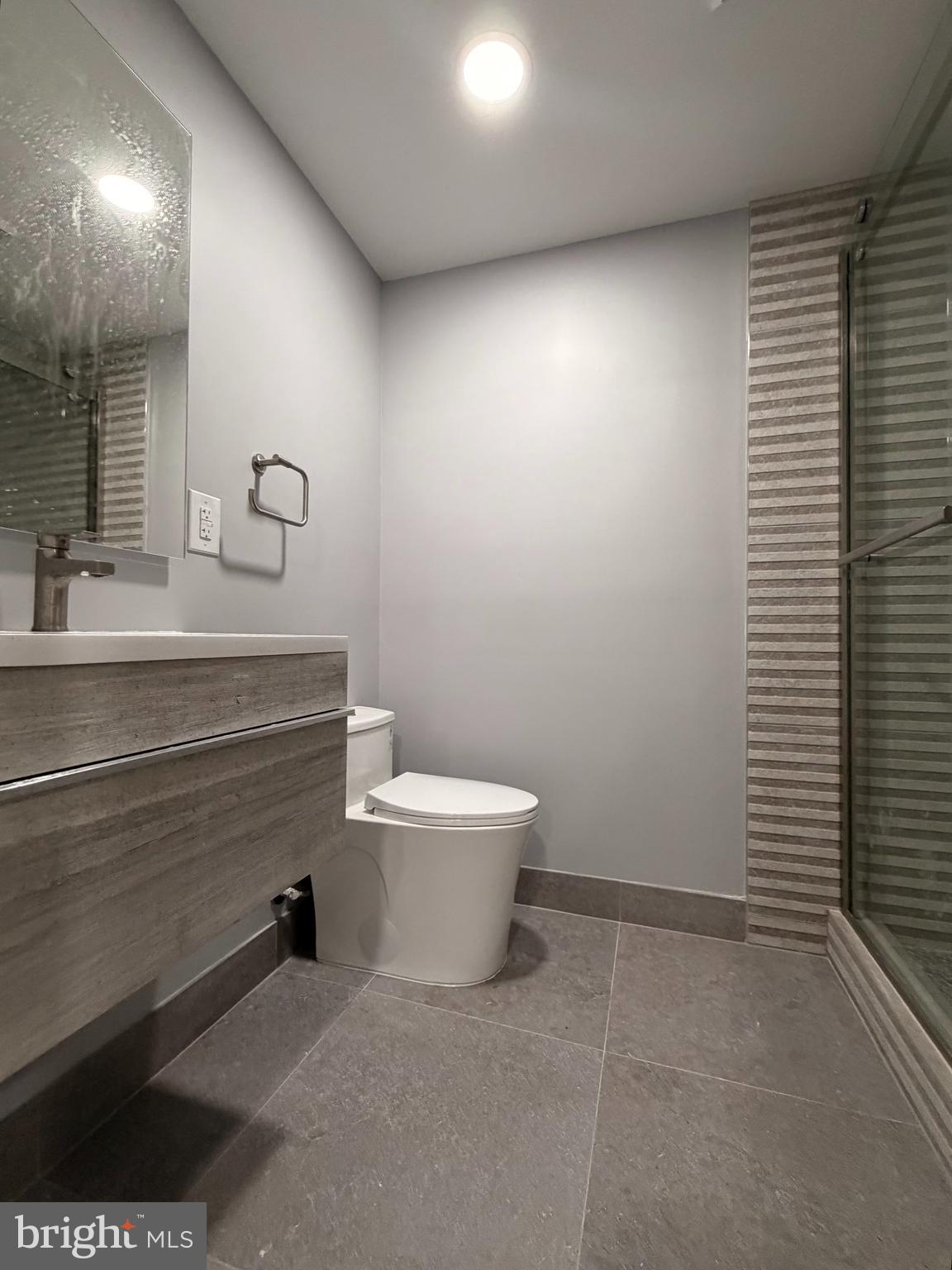 726 Roxboro Place Northwest Washington, DC 20011 - Photo 6 of 21 a bathroom with a sink a toilet and mirror