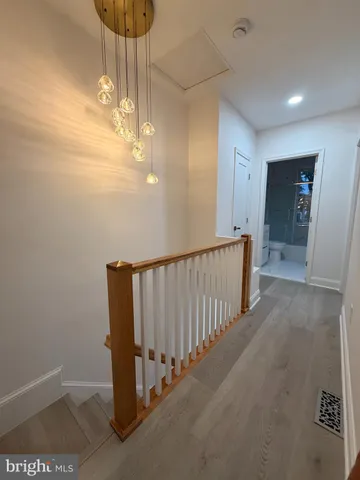 a view of a hallway with a chandelier