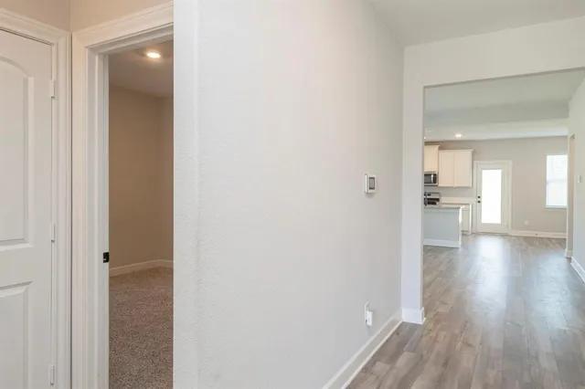 a view of a hallway and wooden floor