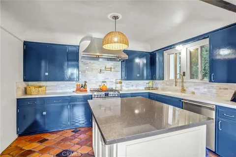 a kitchen with a sink a stove and cabinets