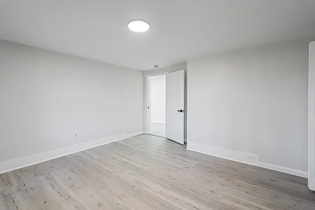 a view of an empty room and wooden floor
