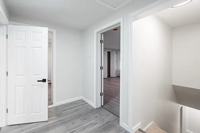 a view of a hallway with wooden floor