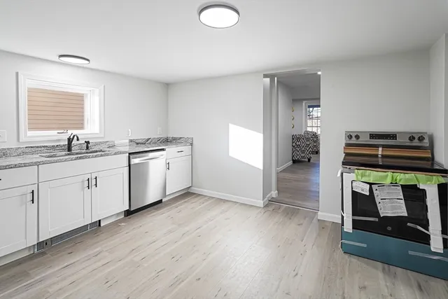 a kitchen with stainless steel appliances a stove a sink and a microwave