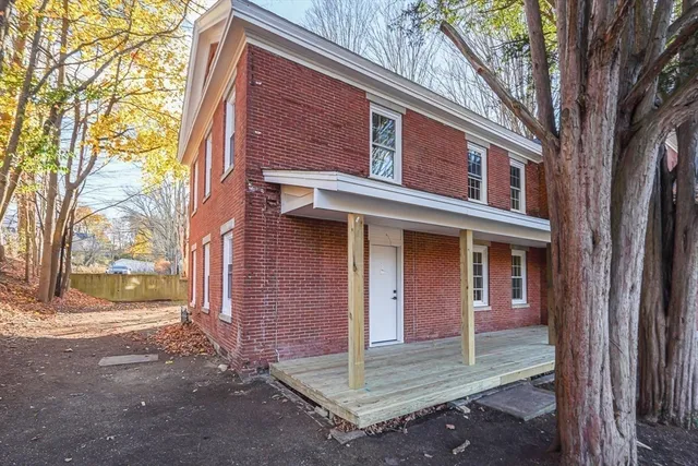a view of a brick house with a large windows