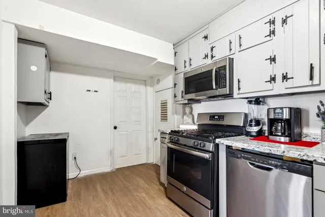 a kitchen with stainless steel appliances a stove a microwave and a refrigerator