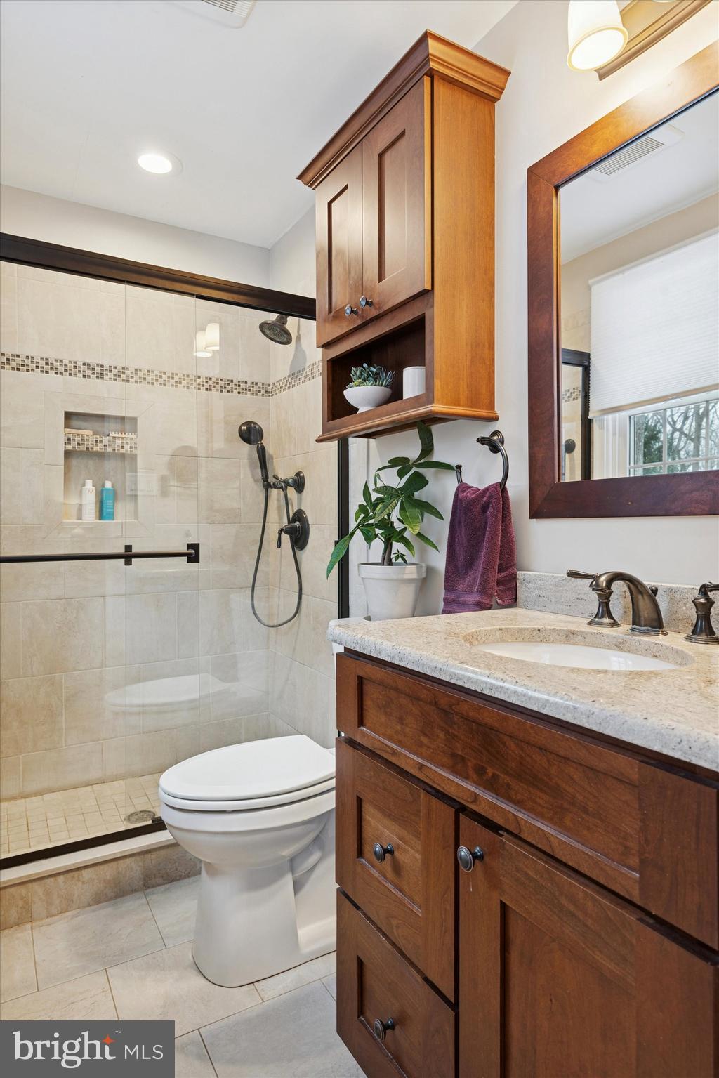1052 West Valley Hill Road Malvern, PA 19355 - Photo 16 of 25 a bathroom with a granite countertop toilet sink and mirror