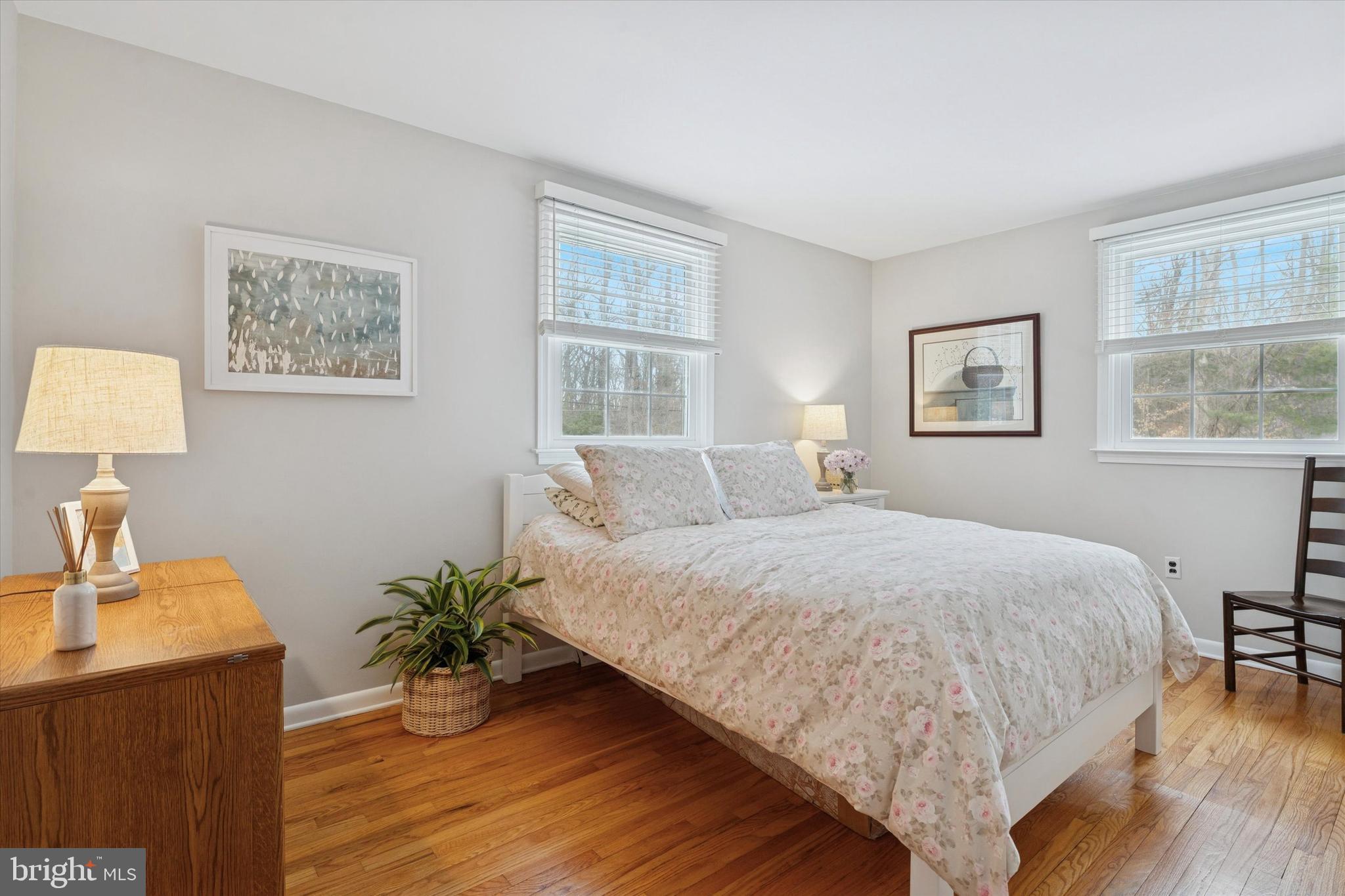 1052 West Valley Hill Road Malvern, PA 19355 - Photo 17 of 25 a bedroom with a large bed and a desk