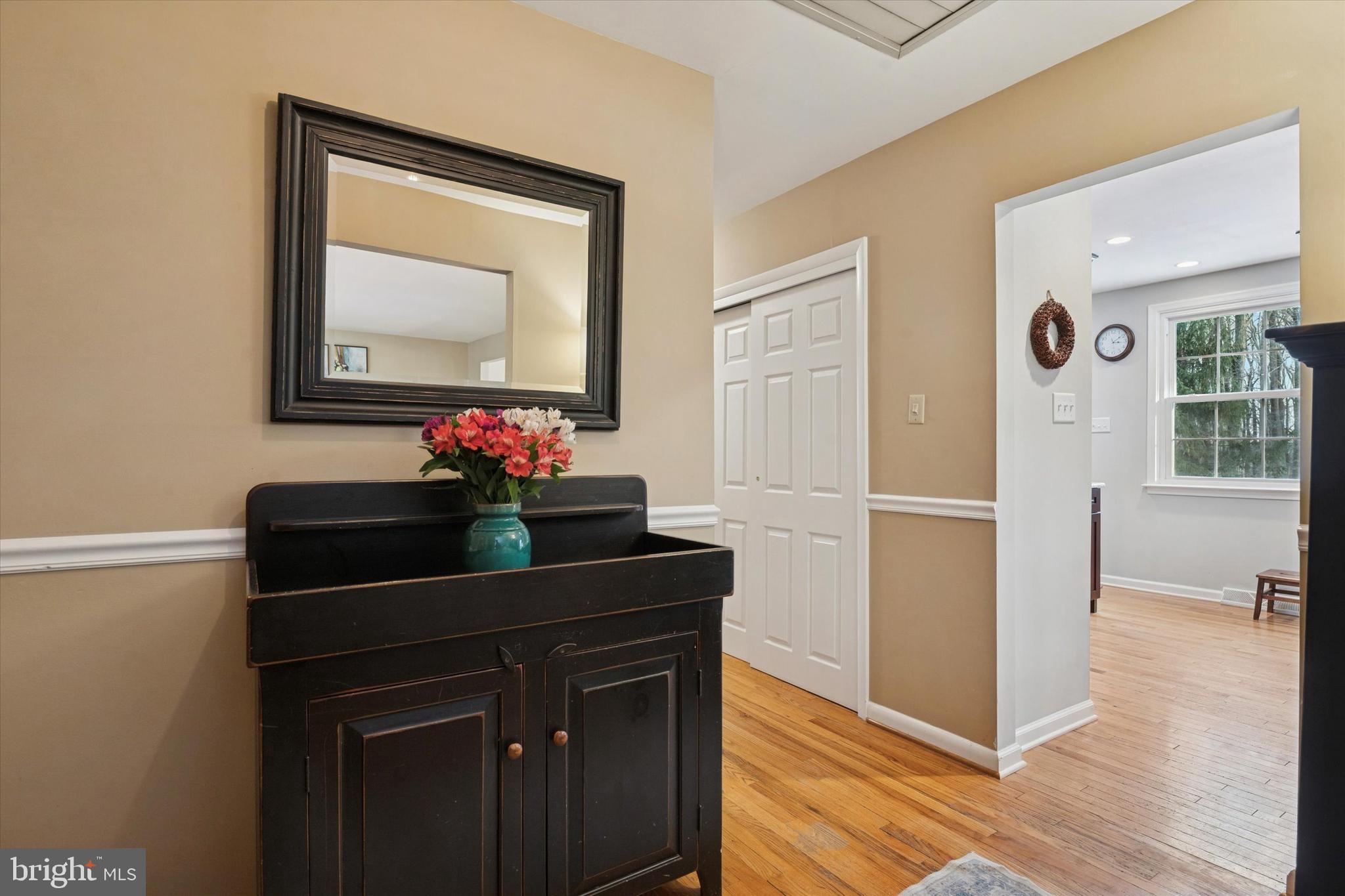 1052 West Valley Hill Road Malvern, PA 19355 - Photo 7 of 25 a room with painting on the wall and a potted plant