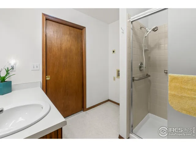 a kitchen with a sink cabinets and wooden floor