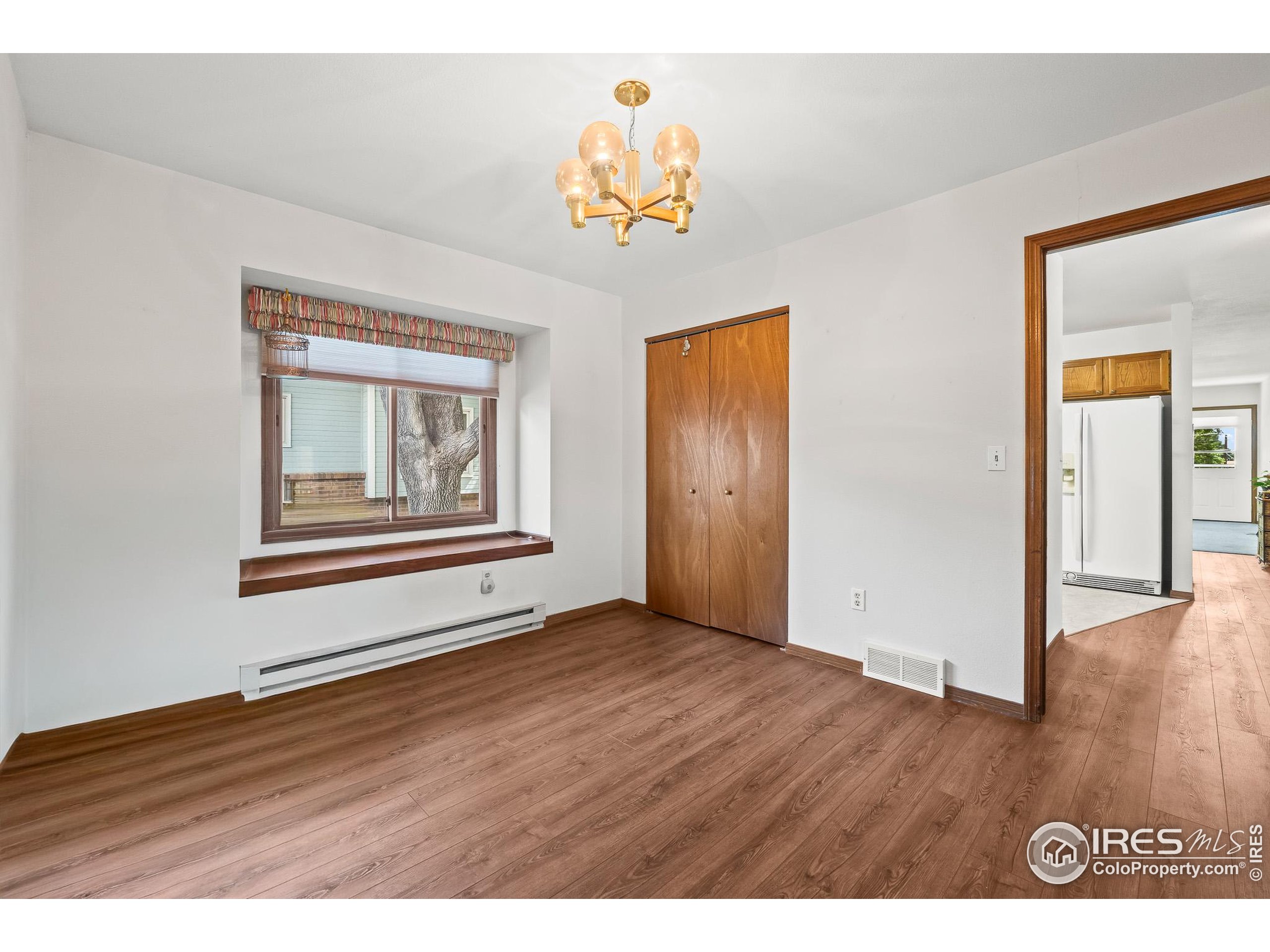1100 South Taft Avenue, Unit 46 Loveland, CO 80537 - Photo 21 of 31 a view of an empty room with wooden floor and a window