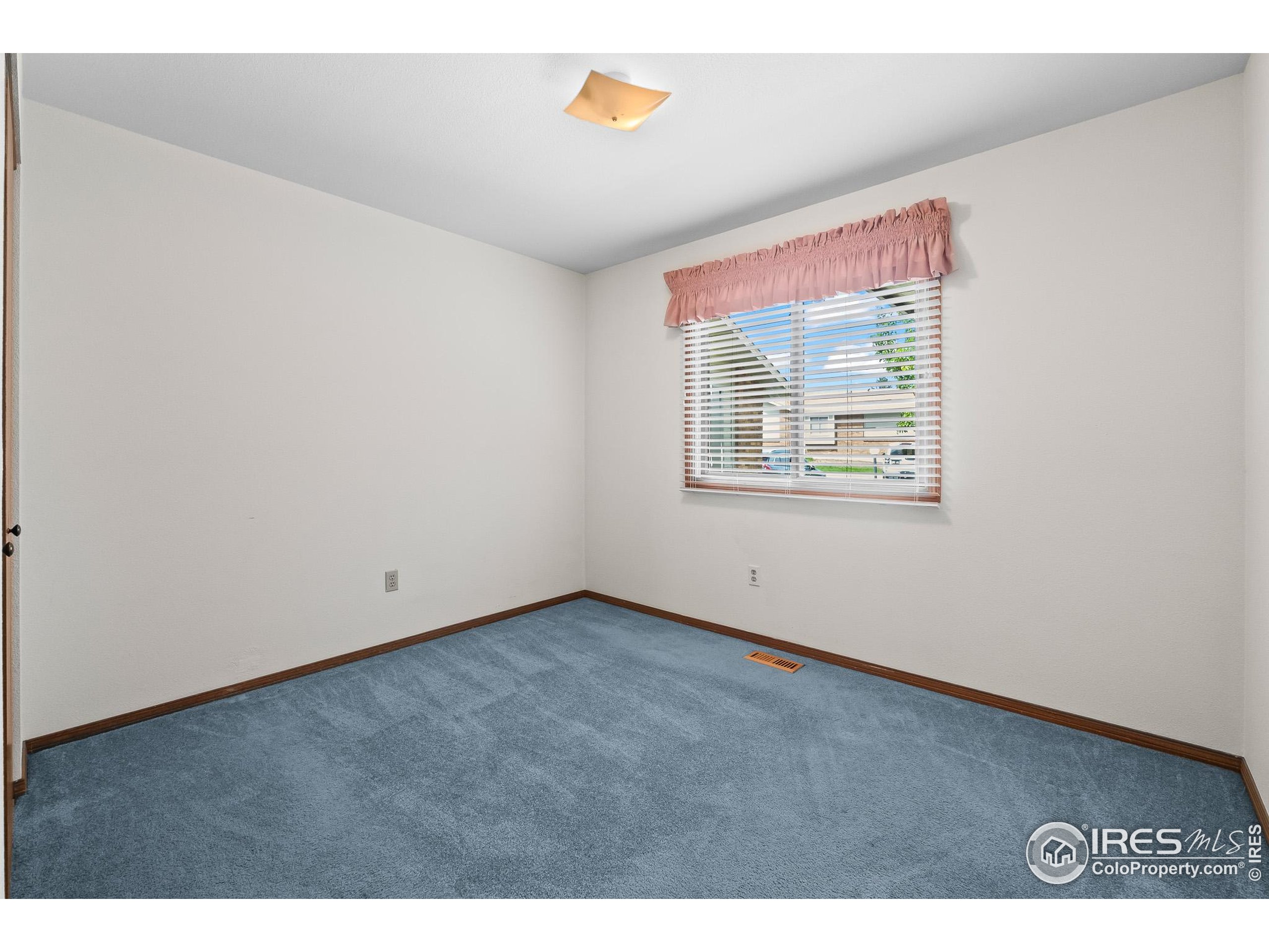 1100 South Taft Avenue, Unit 46 Loveland, CO 80537 - Photo 23 of 31 a view of an empty room with a window