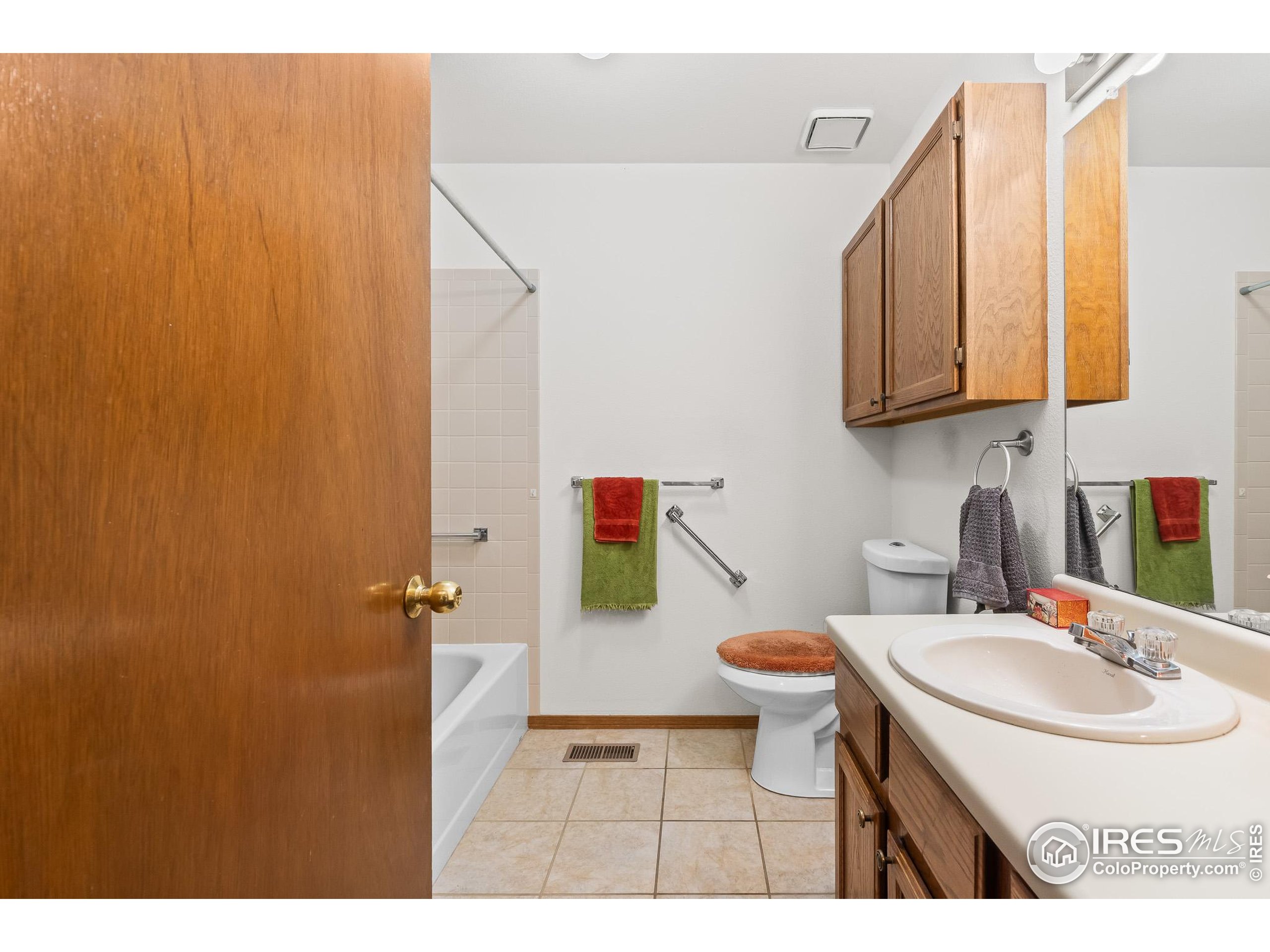 1100 South Taft Avenue, Unit 46 Loveland, CO 80537 - Photo 25 of 31 a bathroom with a sink a toilet and mirror