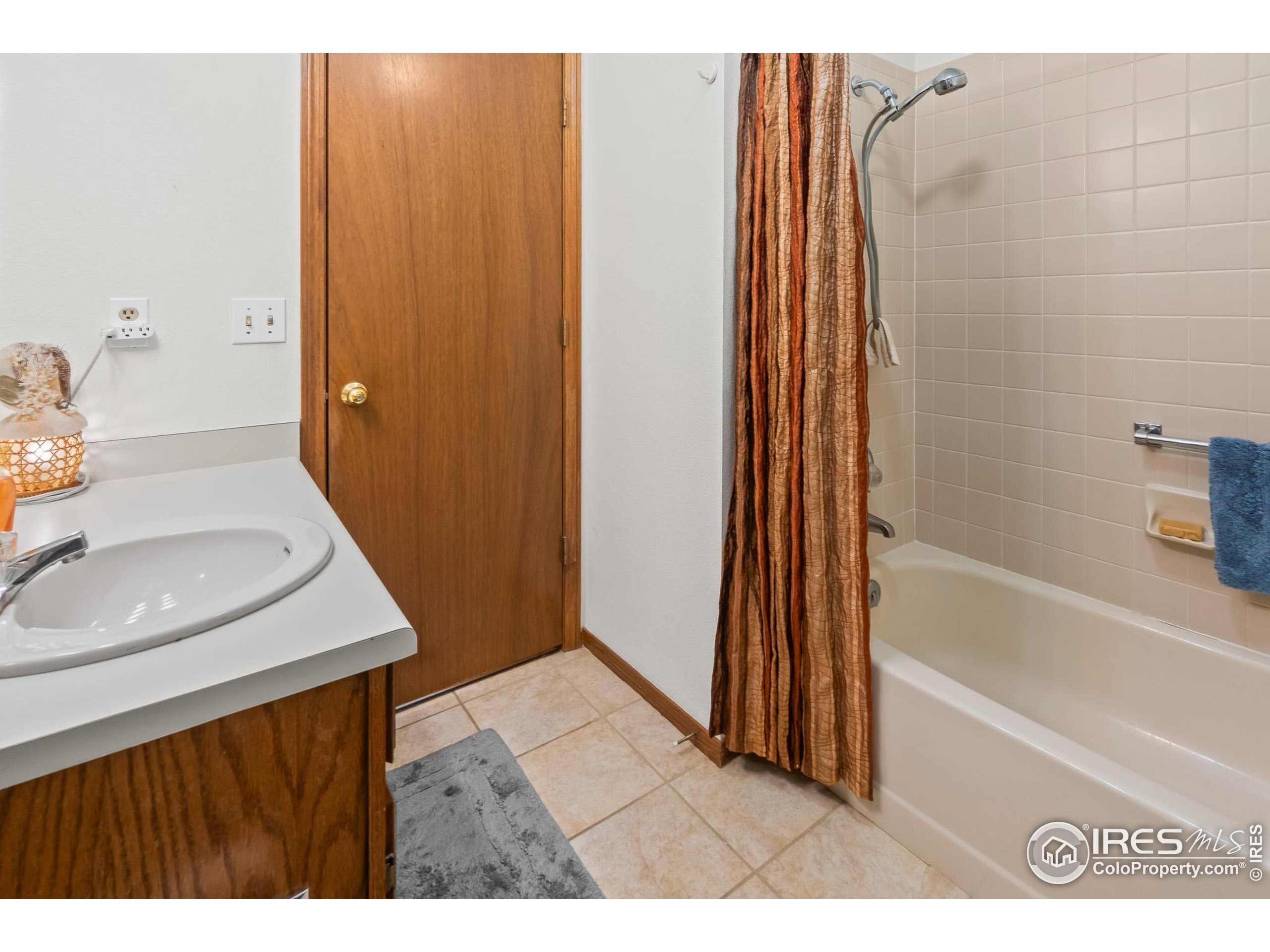 1100 South Taft Avenue, Unit 46 Loveland, CO 80537 - Photo 27 of 31 a bathroom with a sink a toilet and shower