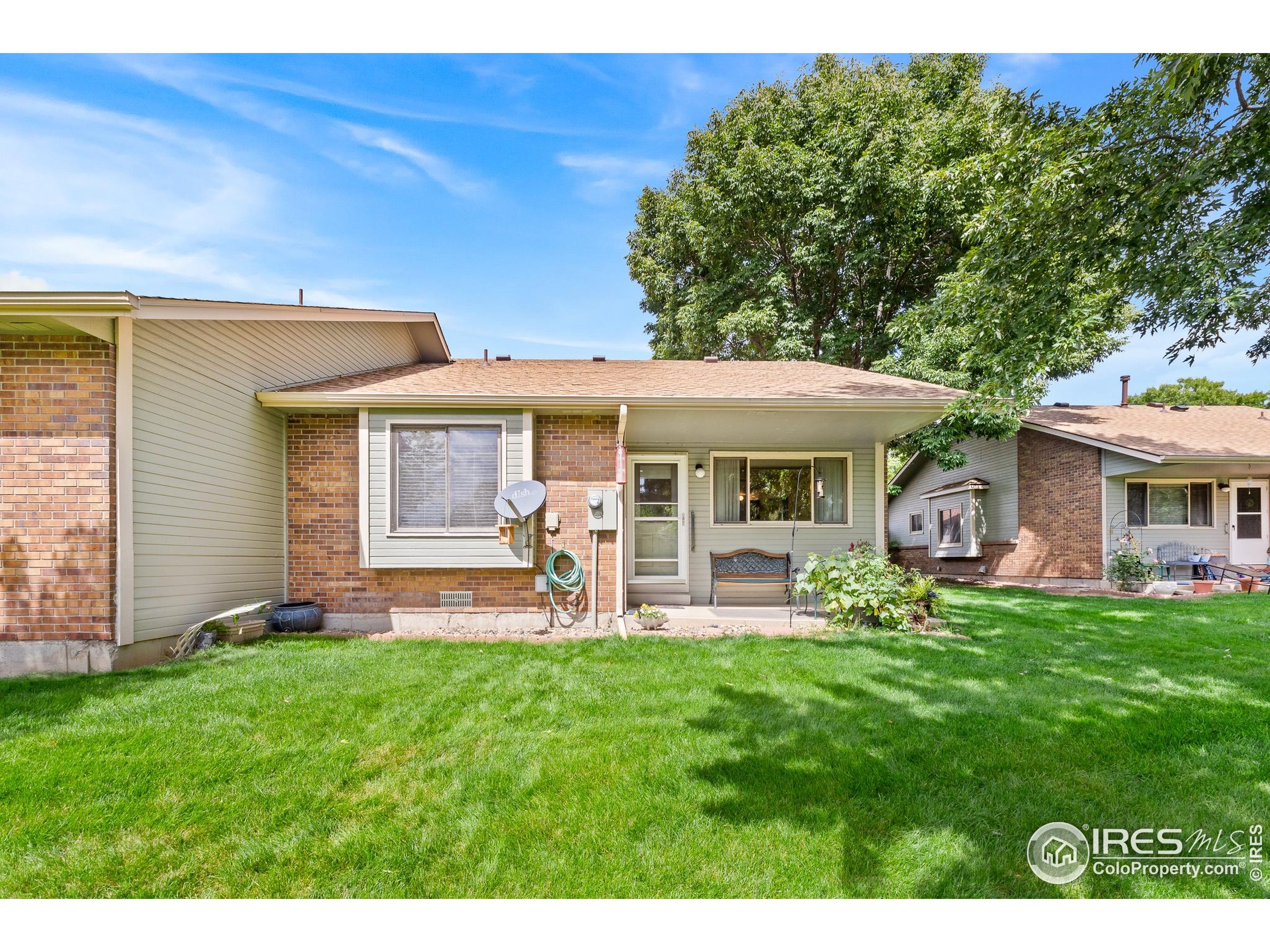1100 South Taft Avenue, Unit 46 Loveland, CO 80537 - Photo 28 of 31 a front view of a house with a garden and patio
