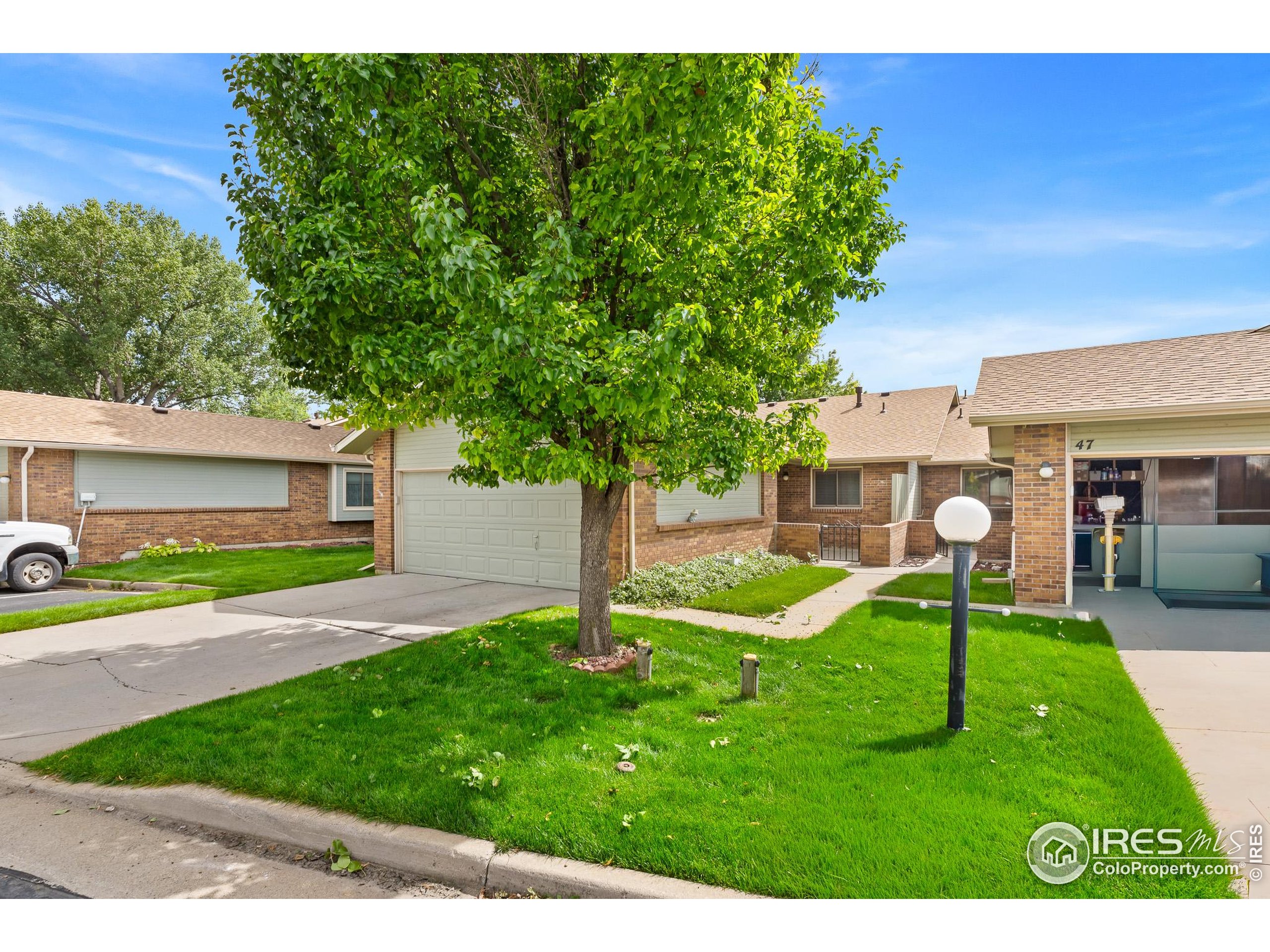 1100 South Taft Avenue, Unit 46 Loveland, CO 80537 - Photo 3 of 31 a view of a house with a yard and a garden