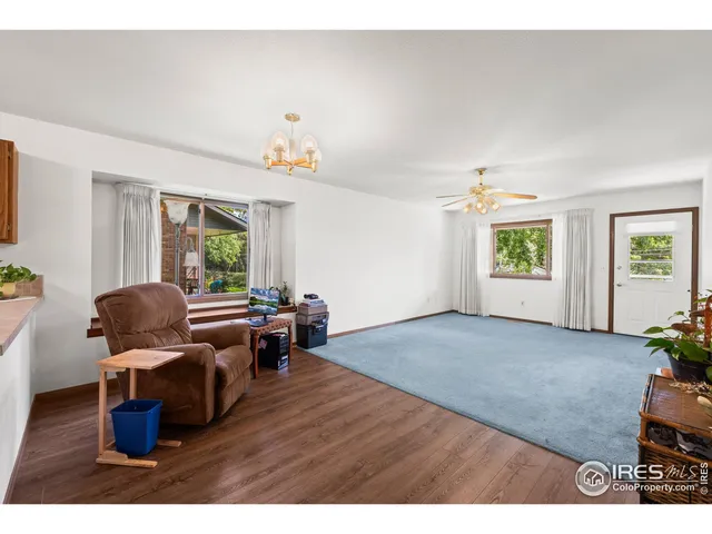 a living room with furniture windows and wooden floor