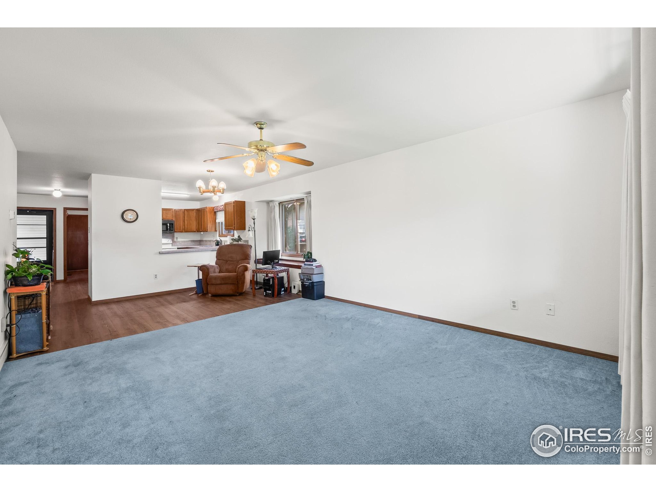 1100 South Taft Avenue, Unit 46 Loveland, CO 80537 - Photo 6 of 31 a living room with furniture and a window
