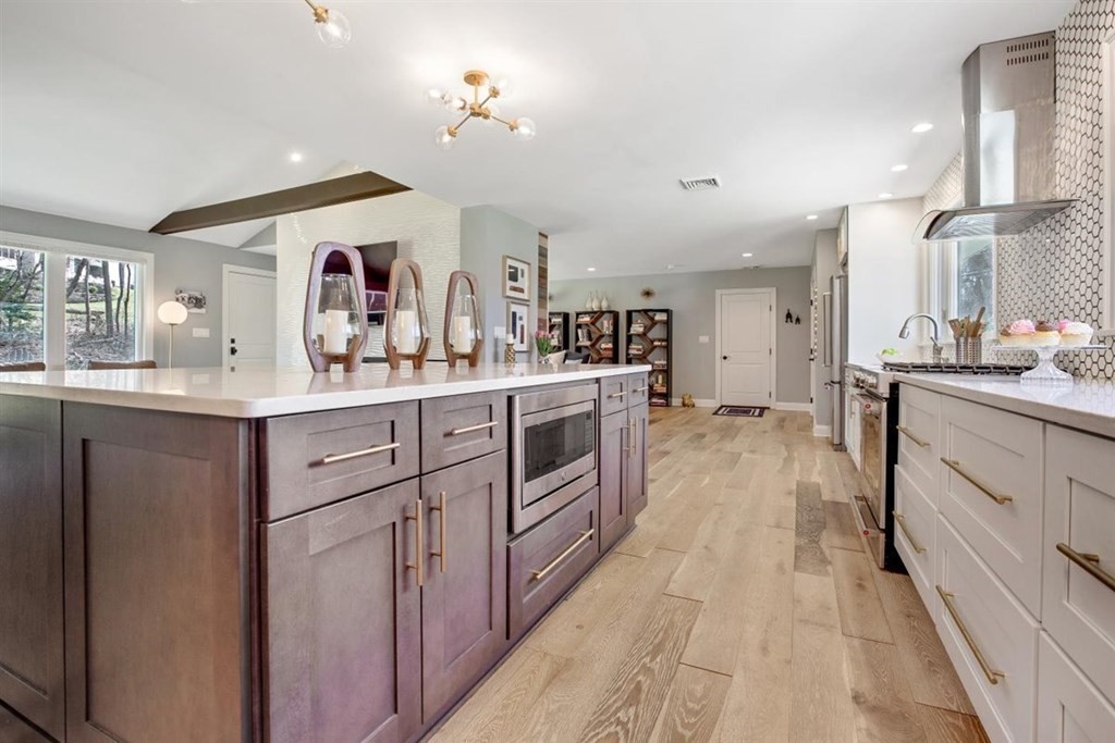 2 West Knoll Road Andover, MA 01810 - Photo 6 of 29 a kitchen with stainless steel appliances granite countertop a sink and cabinets